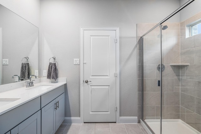 bathroom with tile patterned flooring, vanity, and an enclosed shower