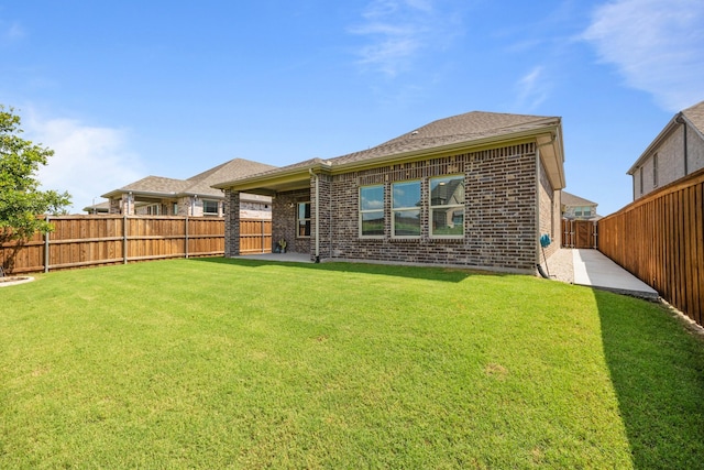 rear view of house with a lawn