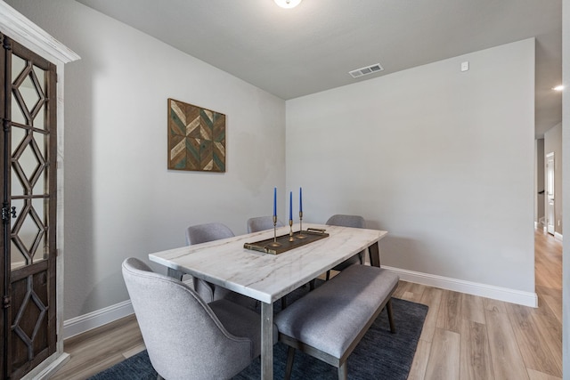 dining space with light wood-type flooring