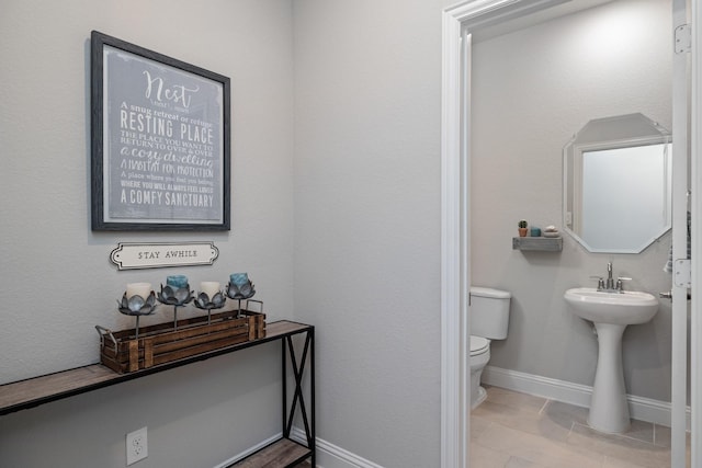 bathroom featuring tile patterned floors and toilet