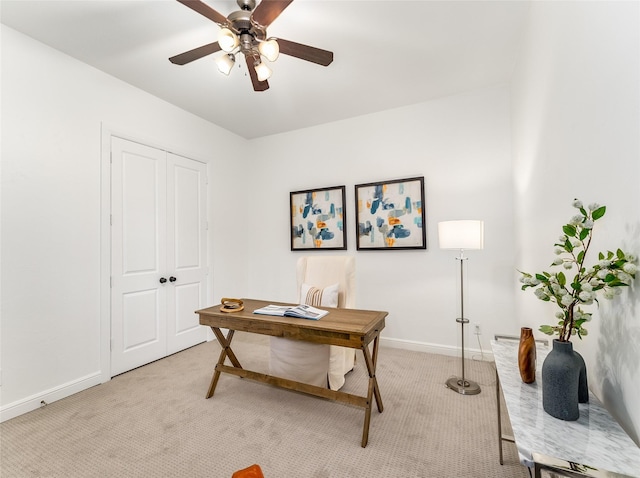 office space featuring light carpet and ceiling fan