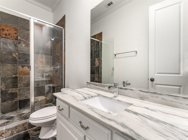 bathroom with vanity, toilet, a shower with door, and ornamental molding