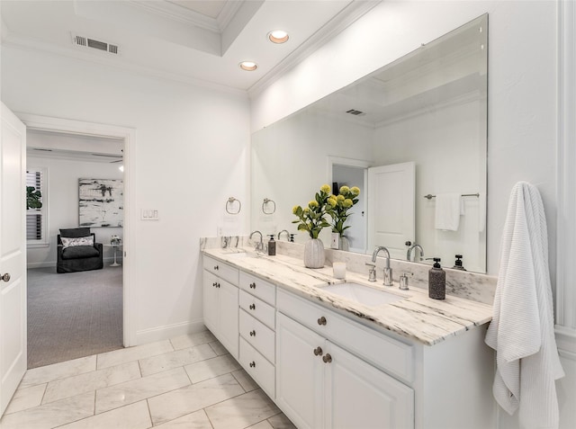 bathroom featuring vanity, a raised ceiling, and crown molding