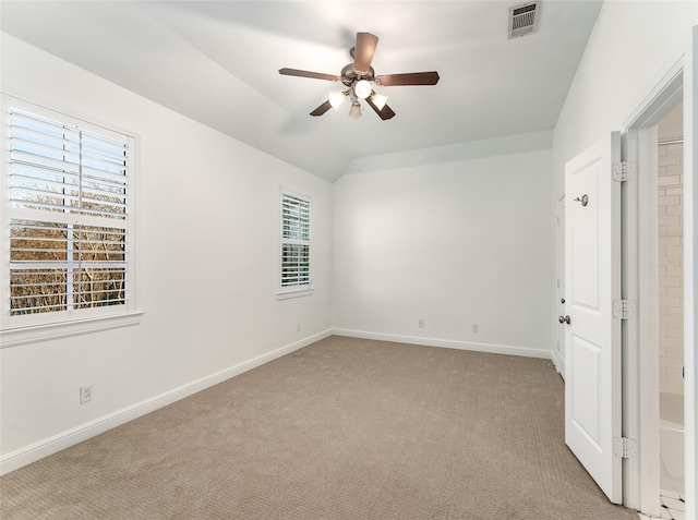 unfurnished room with light carpet, a wealth of natural light, ceiling fan, and lofted ceiling