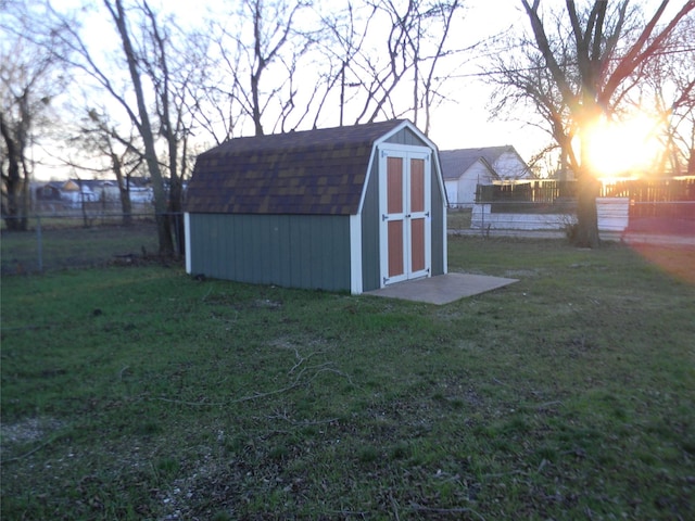 outdoor structure at dusk featuring a yard