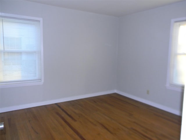 spare room with dark hardwood / wood-style floors