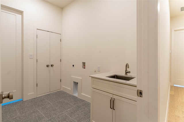 washroom featuring hookup for a washing machine, sink, cabinets, and hookup for an electric dryer