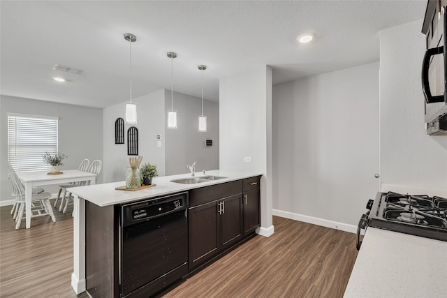 kitchen with dark brown cabinetry, dishwasher, sink, dark hardwood / wood-style flooring, and pendant lighting