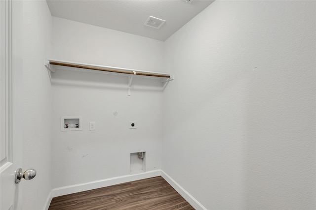 clothes washing area with electric dryer hookup, hookup for a gas dryer, washer hookup, and hardwood / wood-style flooring