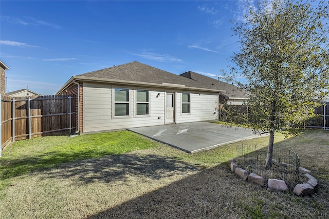 back of property featuring a yard and a patio area