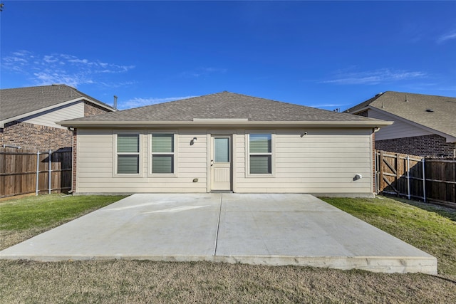 rear view of property with a lawn and a patio area