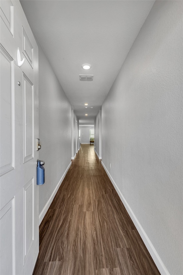 hallway with dark hardwood / wood-style floors