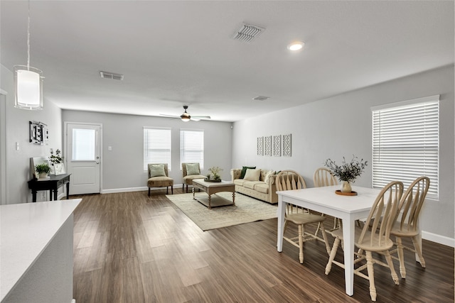 dining room featuring ceiling fan and dark wood-type flooring