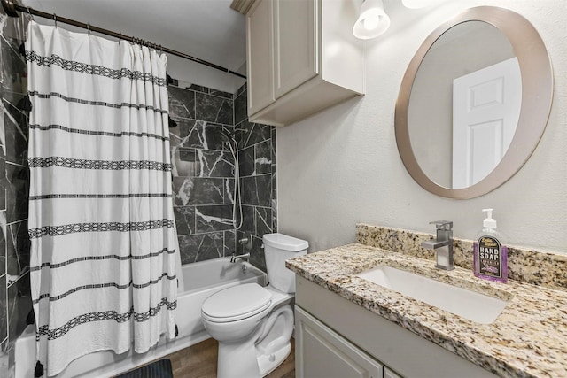 full bathroom featuring toilet, shower / bath combo, and vanity