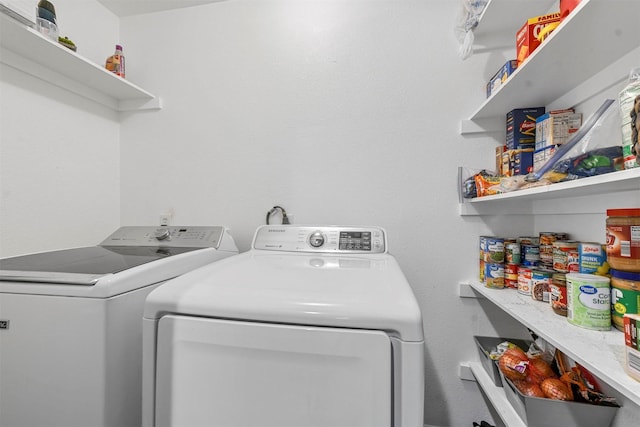 clothes washing area featuring independent washer and dryer