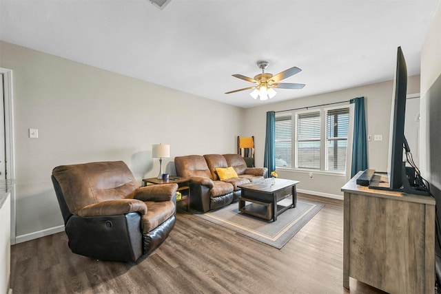 living room featuring ceiling fan and hardwood / wood-style floors