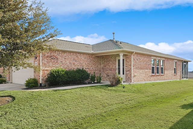 ranch-style house with a garage and a front lawn