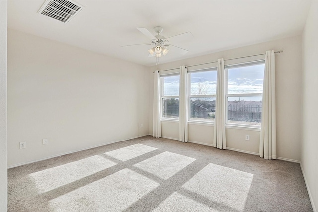 empty room with ceiling fan and light colored carpet