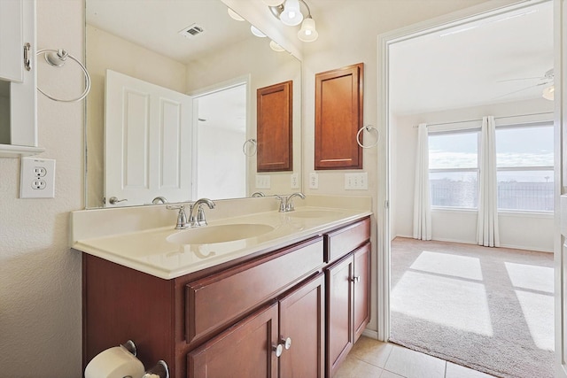 bathroom featuring tile patterned floors, ceiling fan, and vanity