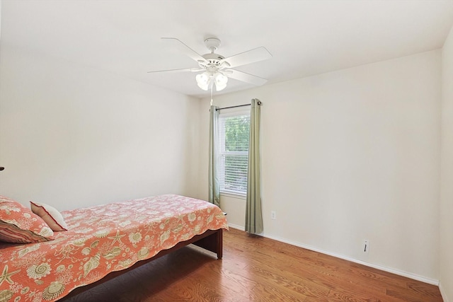 bedroom with wood-type flooring and ceiling fan