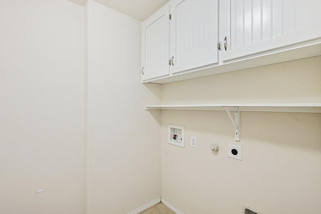 clothes washing area featuring hookup for an electric dryer, hookup for a washing machine, cabinets, gas dryer hookup, and light tile patterned floors