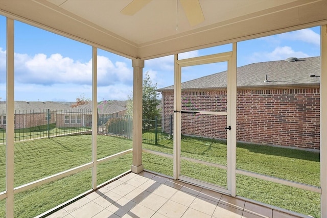 unfurnished sunroom with ceiling fan