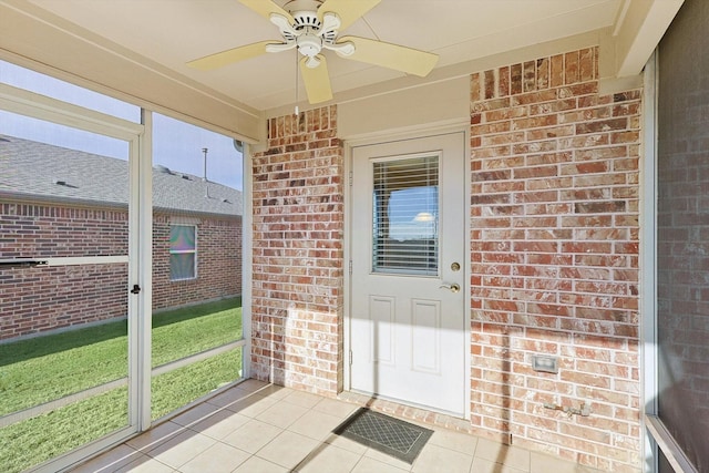 unfurnished sunroom with ceiling fan