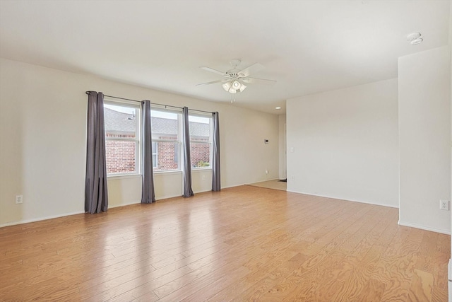 empty room featuring ceiling fan and light hardwood / wood-style flooring