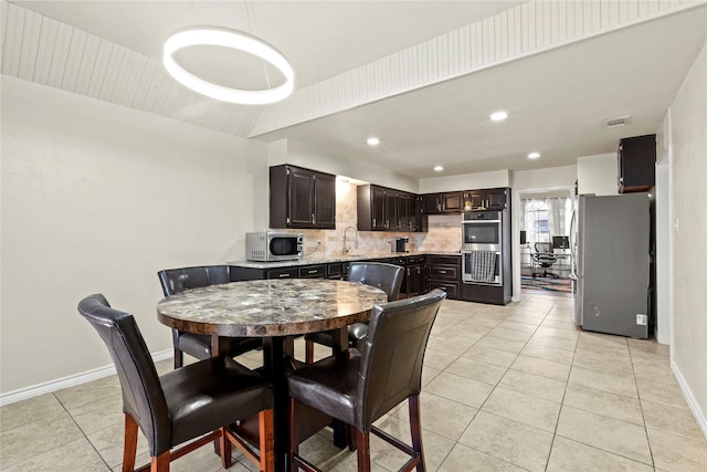 dining room featuring light tile patterned floors and sink