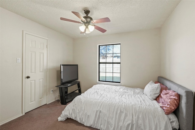 carpeted bedroom featuring a textured ceiling and ceiling fan