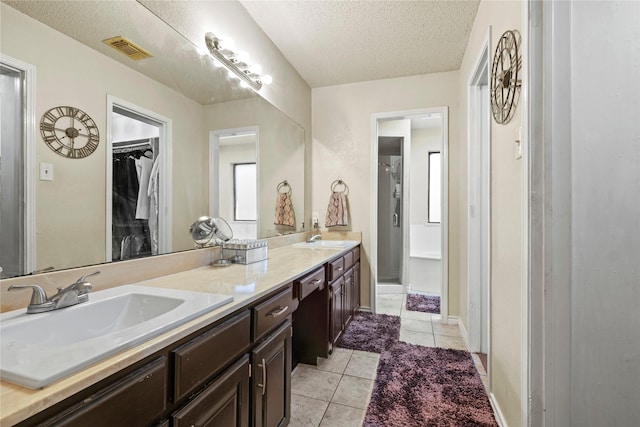 bathroom featuring vanity, a textured ceiling, and tile patterned floors