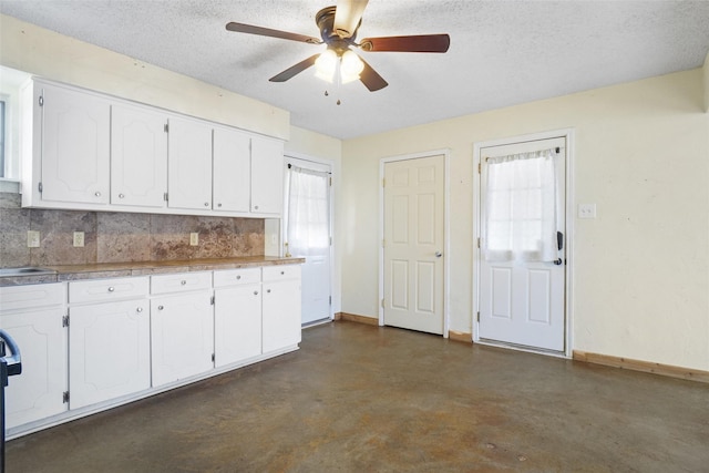 kitchen with ceiling fan, white cabinetry, a textured ceiling, and tasteful backsplash