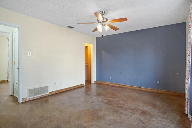 spare room featuring concrete flooring, a textured ceiling, and ceiling fan