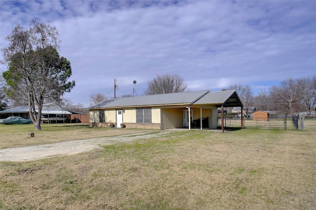 view of side of home featuring a lawn and an outdoor structure