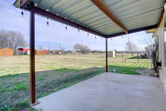 view of yard featuring a patio and a shed