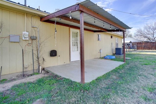 back of house with central air condition unit, a patio area, and a yard