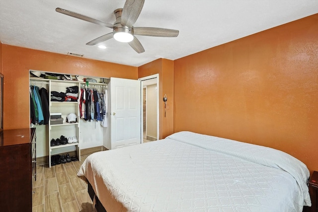 bedroom featuring ceiling fan and a closet