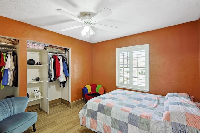 bedroom featuring ceiling fan, a closet, and light hardwood / wood-style floors