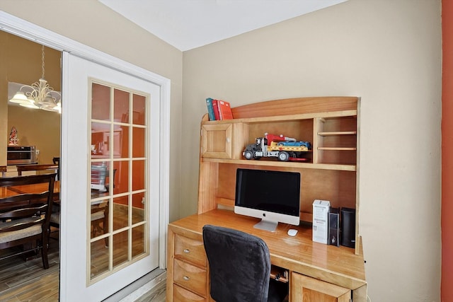 office featuring hardwood / wood-style flooring and an inviting chandelier