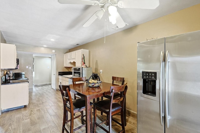 kitchen featuring white cabinets, stainless steel fridge with ice dispenser, light wood-type flooring, and ceiling fan