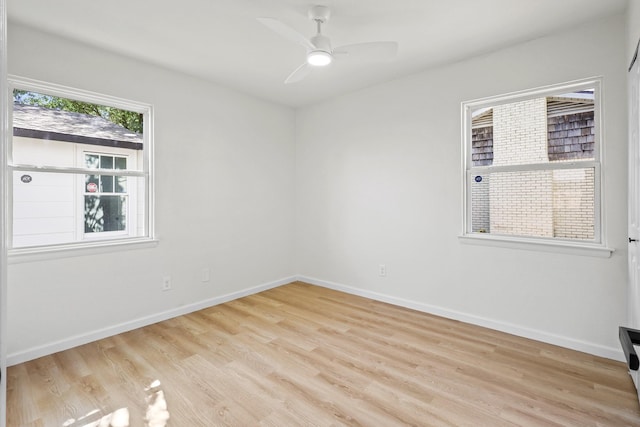 empty room featuring ceiling fan and light wood-type flooring