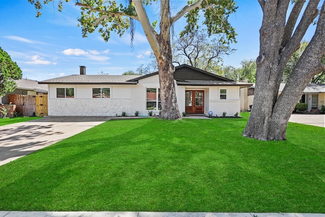 ranch-style house featuring french doors and a front yard