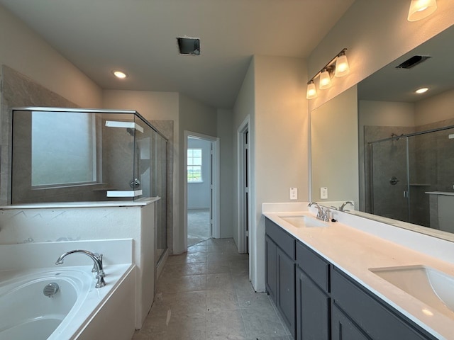 full bathroom featuring a stall shower, a garden tub, and a sink