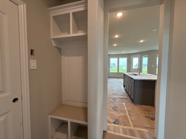 mudroom with recessed lighting and a sink