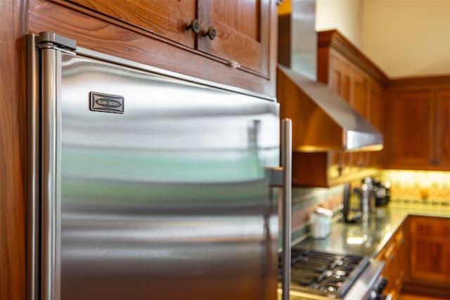 1665 W Belt Line Rd, Cedar Hill, TX 75104 - kitchen with built in fridge, brown cabinetry, and decorative backsplash