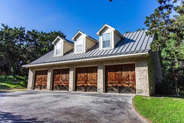 1665 W Belt Line Rd, Cedar Hill, TX 75104 - view of front facade featuring a standing seam roof, stone siding, metal roof, and a garage