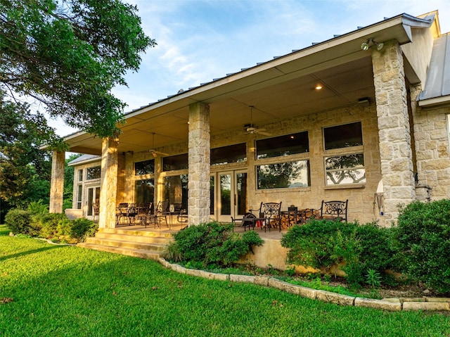 1665 W Belt Line Rd, Cedar Hill, TX 75104 - rear view of property featuring a lawn, ceiling fan, stone siding, and a patio