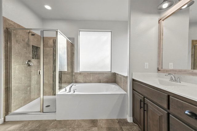 bathroom with vanity and shower with separate bathtub