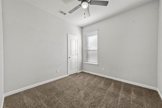 spare room with ceiling fan and carpet floors