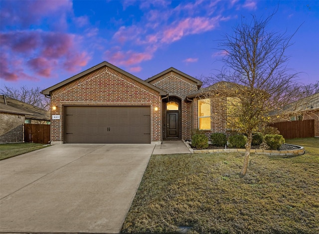 view of front of home featuring a lawn and a garage